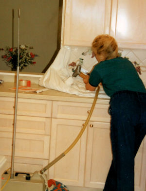 Designer removing relief tiles with a drapery steamer.